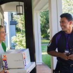 Delivery driver and woman on door step