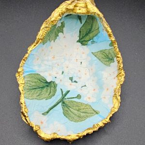 Decorative cut paper with a blue floral pattern framed by a crinkled gold foil edge